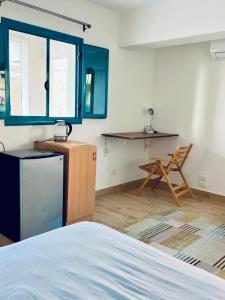 a room with a bed and a table and a chair at Rafiki Hostels - Pyramids in Giza