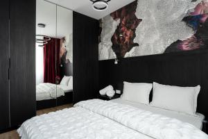 En eller flere senge i et værelse på Sika Diplomat Apartment