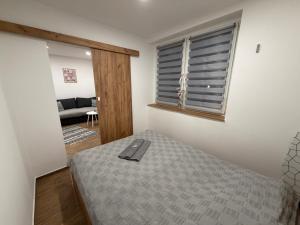 a bedroom with a bed and a window at ApartmentsByMatyrafa-XIV in Tarnowskie Góry