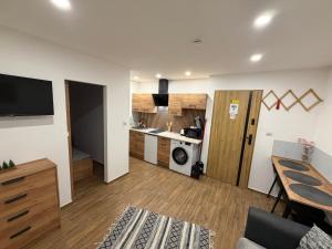 a room with a kitchen and a living room at ApartmentsByMatyrafa-XIV in Tarnowskie Góry