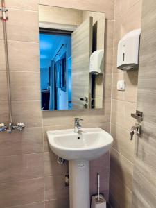 a bathroom with a sink and a mirror at Rafiki Hostels - Pyramids in Giza +51 photos