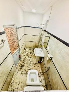 a dirty bathroom with a toilet and a sink at 11 11 Weligama in Weligama +34 photos