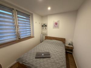 ein kleines Schlafzimmer mit einem Bett und einem Fenster in der Unterkunft ApartmentsByMatyrafa-XIV in Tarnowitz