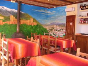 a restaurant with a mural on the wall at Camping Trevélez in Trevélez