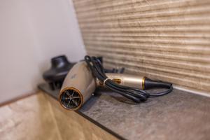 a hair dryer sitting on a counter next to a window at Leeds City Luxe Apartment with Parking, 8 mins to station! in Central Station