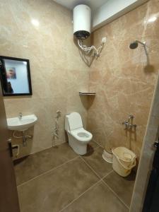 a bathroom with a toilet and a sink at Zeenus Holiday Resort in Yercaud