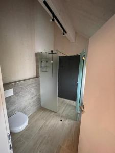 ein Badezimmer mit Toilette und Glasduschkabine in der Unterkunft Moderne Maisonette-Ferienwohnung mit Dachterrasse, Waldblick & Parkplatz in Friedburg