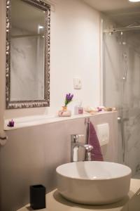 a white bathroom with a sink and a shower at Villa Martina in Komiža +18 photos