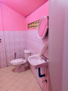 a pink bathroom with a toilet and a sink at Pizza classic resort kohjum in Ban Ko Phrao +22 photos
