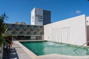 a swimming pool in front of a building at Hotel Buena Vista Express in Bucaramanga