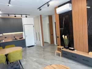 a kitchen with a table and a dining room at Rezidenca Onda in Lezhë