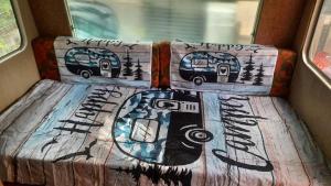 a seat in a bus with graffiti on it at Tinyhaus am Flughafen, der DLR und ESA in Cologne