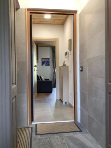 a hallway with a door leading to a living room at Fuga dalla città in Grosotto