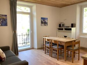 a living room with a table and a couch at Fuga dalla città in Grosotto +15 photos