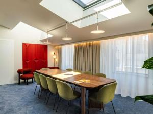 a conference room with a wooden table and chairs at TRIBE Krakow Old Town in Kraków