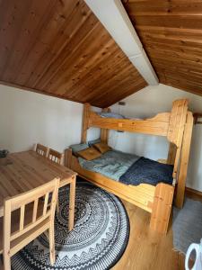 a room with two bunk beds and a table at Våmåbadets Camping in Våmhus