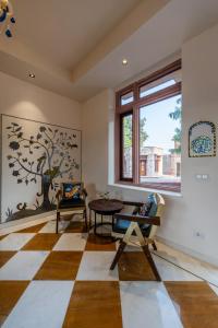 a living room with a checkered floor and a window at SeraiBagh Resort in Khilchipur