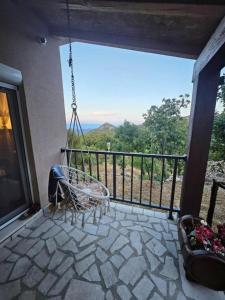 a porch with a swinging chair on a balcony at Village Drago in Cetinje