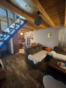 a living room with couches and a blue staircase at Village Drago in Cetinje