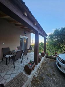 a patio with chairs and a table and a car at Village Drago in Cetinje