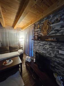 a living room with a couch and a fireplace at Village Drago in Cetinje