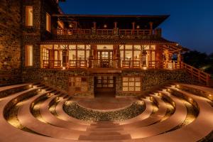 an outdoor amphitheater in front of a building at night at SeraiBagh Resort in Khilchipur +10 photos