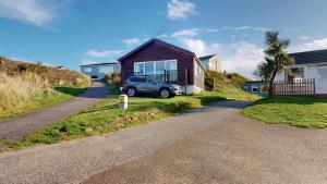 a car parked in the driveway of a house at D22 Sandelite, Riviere Towans in Hayle +8 photos
