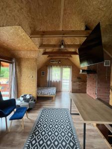 a large living room with a table and a couch at Domek LuźnAgro Góry Sowie in Łomnica