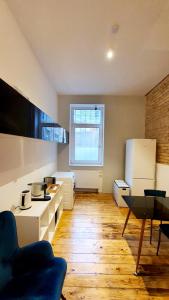 a kitchen with white appliances and a wooden floor at Zimmer im Erdgeschoss II in Mannheim