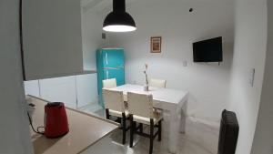 a kitchen with a table and chairs and a tv at Artin House Mendoza in Ciudad Lujan de Cuyo
