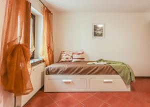 een kleine slaapkamer met een bed en een raam bij Casa Lukezovi 