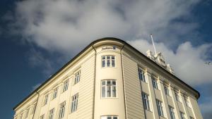 a building with a flag on the top of it at Radisson Blu 1919 Hotel, Reykjavík in Reykjavík