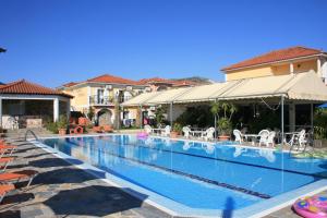a swimming pool in a villa with a house at Metaxa Hotel in Kalamaki