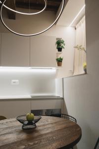 a kitchen with a wooden table and a circular light at Loft SPA Massa Marittima in Massa Marittima +26 photos
