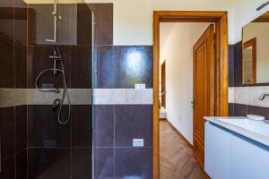 a bathroom with a shower and a sink at Villa Antonina & Mino in Cala Liberotto +14 photos