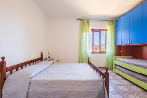 a bedroom with a bed and a window at Villa Antonina & Mino in Cala Liberotto