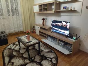 a living room with a television and a coffee table at La Han in Făgăraş