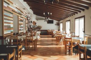 ein Restaurant mit Tischen und Stühlen in einem Raum in der Unterkunft Ostatu de zegama in Zegama
