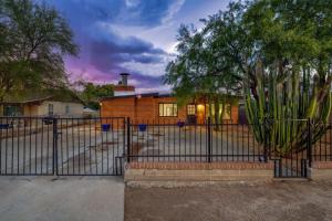 a fence in front of a house at 24th St (Deepak & Jackie) in Tucson