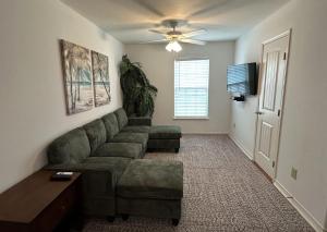 a living room with a couch and a table at The Beach Peach in Port Aransas