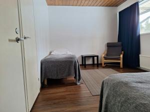 a bedroom with a table and a chair and a window at Spacious Apartment for 5 in Sodankylä