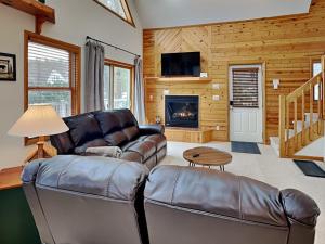 a living room with leather furniture and a fireplace at Almost Heaven in Swanton