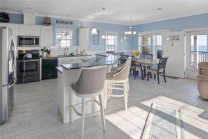 a kitchen and living room with a table and chairs at Beachfront Home with Huge Deck in Bolivar Peninsula