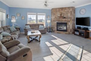 a living room with a couch and a fireplace at Beachfront Home with Huge Deck in Bolivar Peninsula