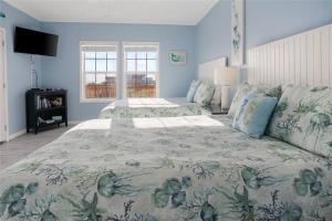 a large bedroom with two beds and a window at Beachfront Home with Huge Deck in Bolivar Peninsula