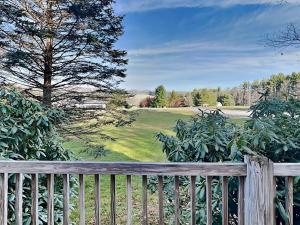 a wooden fence in front of a green field at Almost Heaven in Swanton