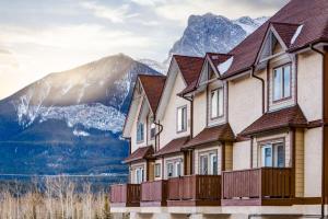 a row of houses in front of a mountain at Cozy Mountain View Condo Close to DT Canmore in Canmore
