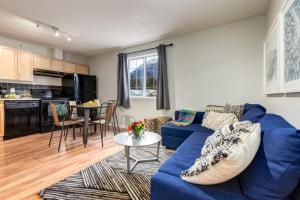 a living room with a blue couch and a table at Delightful 2BR Mountain Escape in Canmore in Canmore