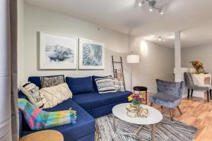 a living room with a blue couch and a table at Delightful 2BR Mountain Escape in Canmore in Canmore