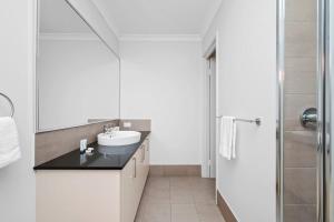 a white bathroom with a sink and a shower at The Sunlit Expansive Hideaway in Alkimos +31 photos
